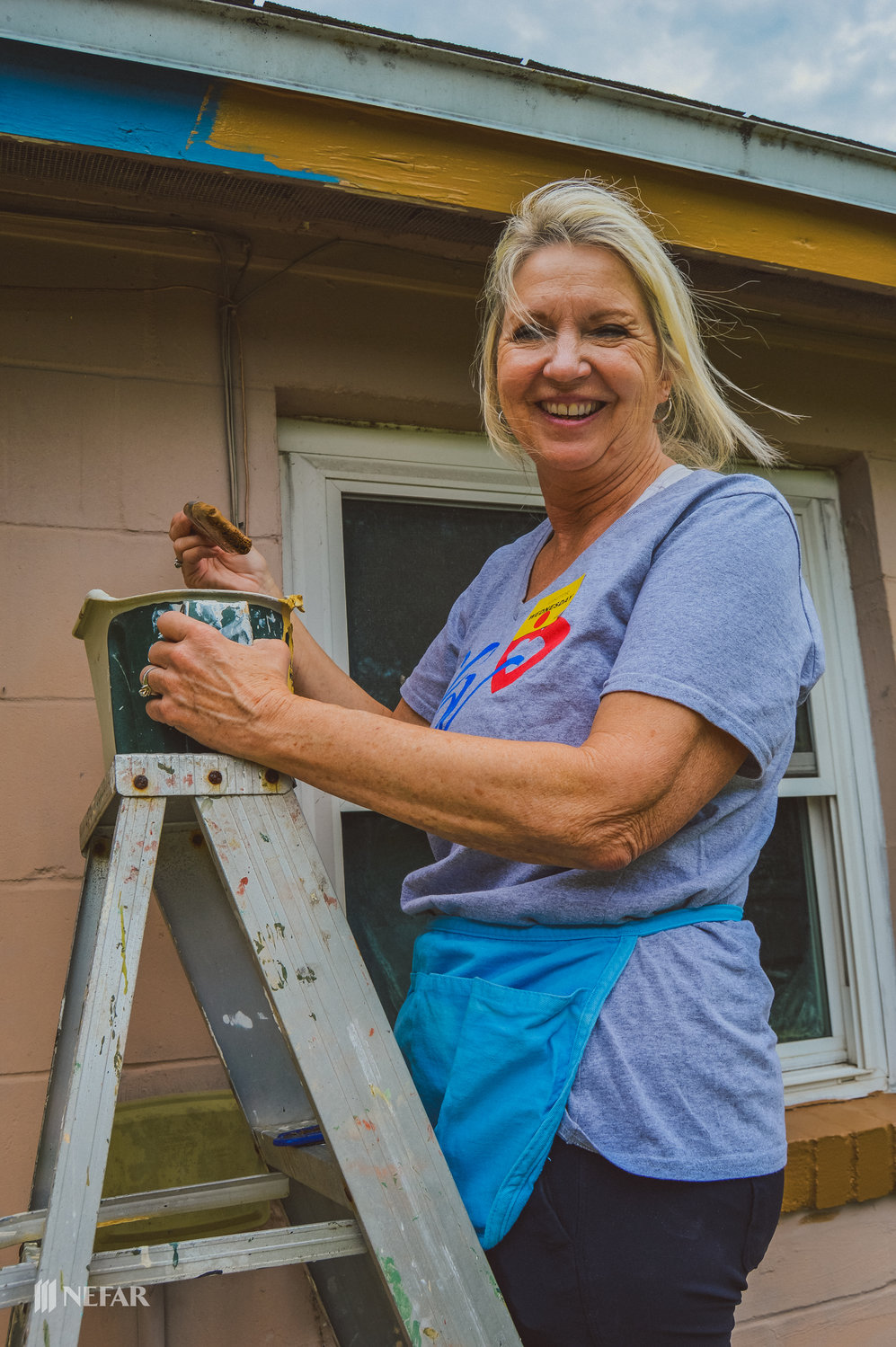 NEFAR Realtor Carole Bayer of Coldwell Banker Vanguard Realty in Ponte Vedra paints trim during a wheelchair ramp building event sponsored by the Northeast Florida Association of Realtors March 23.